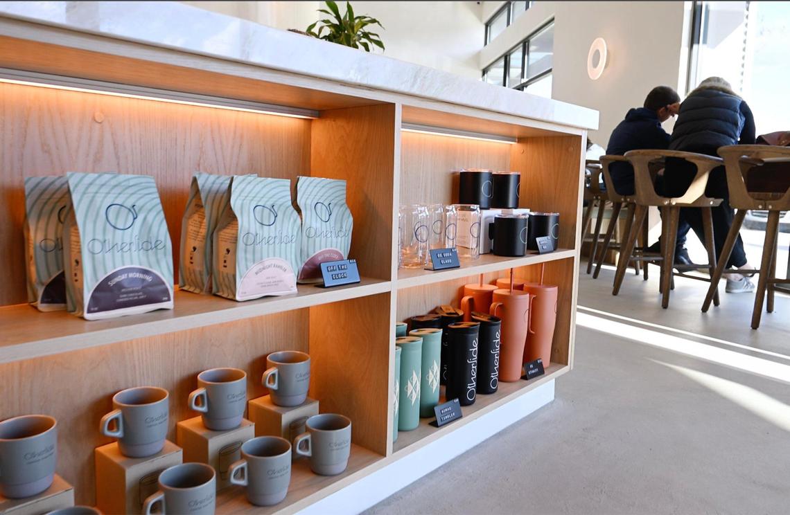 Bags of coffee alongside mugs for sale at Otherside Cafe, Brandon Smittcamp and his partners’ latest venture offering espresso drinks, food and desserts in northeast Fresno.