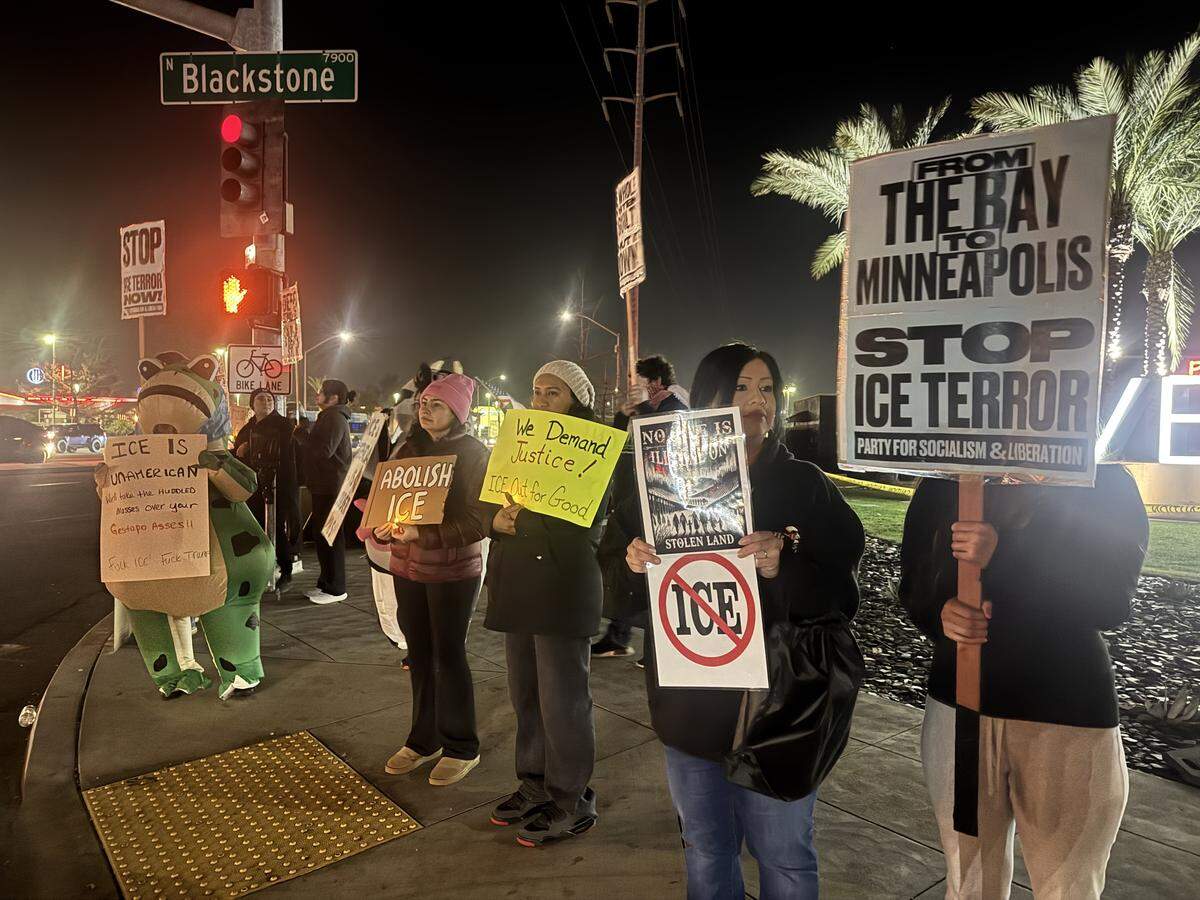 Protesters line the sidewalks surrounding River Park Shopping Center in Fresno after the killing of Alex Pretti in Minneapolis on Jan. 25, 2026.