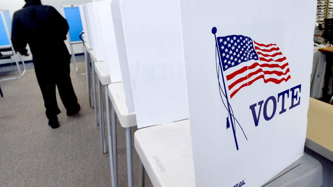 An early morning voter makes his way to a booth to cast his ballot at the Fresno County Elections Office in downtown Fresno, March 3, 2020.