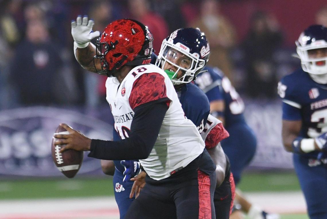 Fresno State defensive end David Perales pressures San Diego State quarterback Jalen Mayden, Saturday, Oct. 29, 2022 in Fresno.