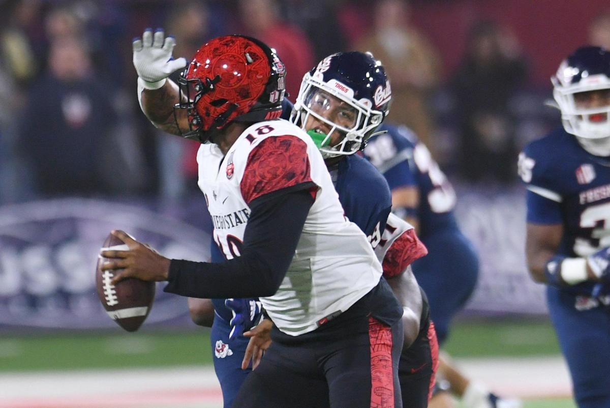 Fresno State defensive end David Perales pressures San Diego State quarterback Jalen Mayden in the Bulldogs’ 32-28 victory in October. Perales, who injured an ankle in the final regular season game, is expected to play against Washington State in the L.A. Bowl on Saturday at SoFi Stadium in Los Angeles.