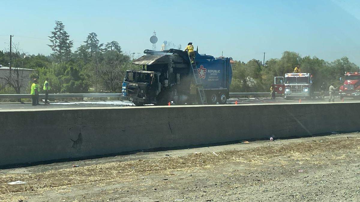 A garbage truck caught on fire on a Fresno highway on Wednesday, Aug. 31, 2022.