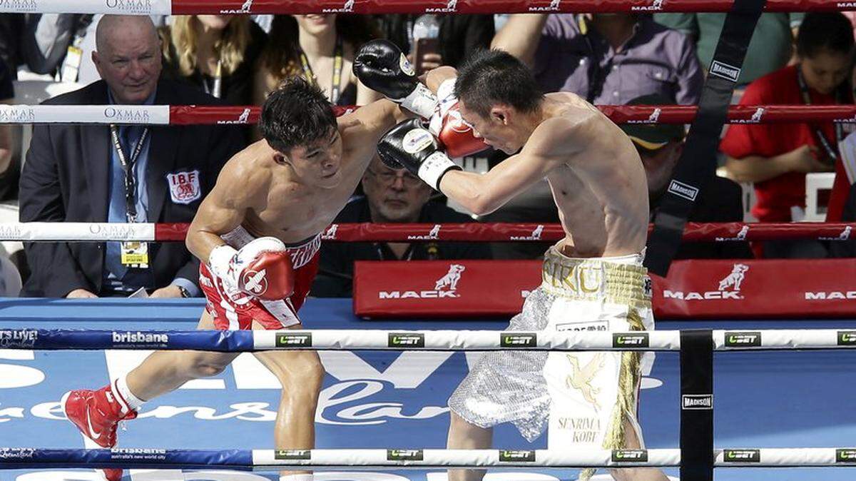 Jerwin Ancajas of the Philippines, left, trades punches with Teiru Kinoshita  of Japan during their IBF world junior bantamweight title fight in Brisbane, Australia on July 2, 2017. Ancajas will defend his title against countryman Jonas Sultan at the Save Mart Center on Saturday, May 26, 2018.