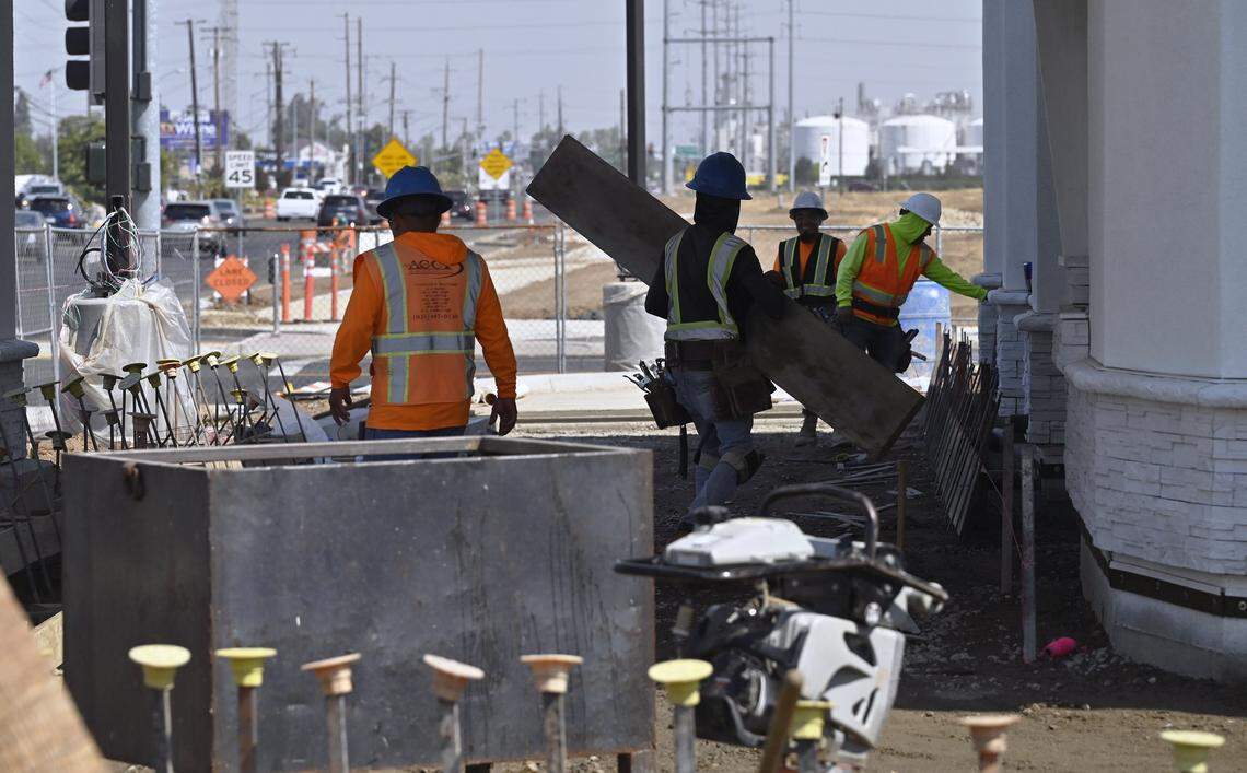 Workers are seen at an In-N-Out while development continues at Fancher Creek Wednesday, Sept. 3, 2025 in Fresno.