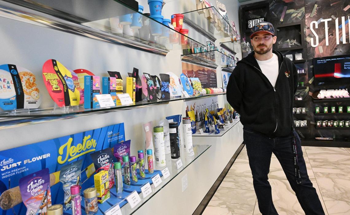 Josh Rogina looks over some of the product he sells at The Station, Fresno’s third and newest cannabis dispensary located in a former bank on Shaw Ave. across from Fashion Fair. Photographed Tuesday, Dec. 5, 2023 in Fresno.