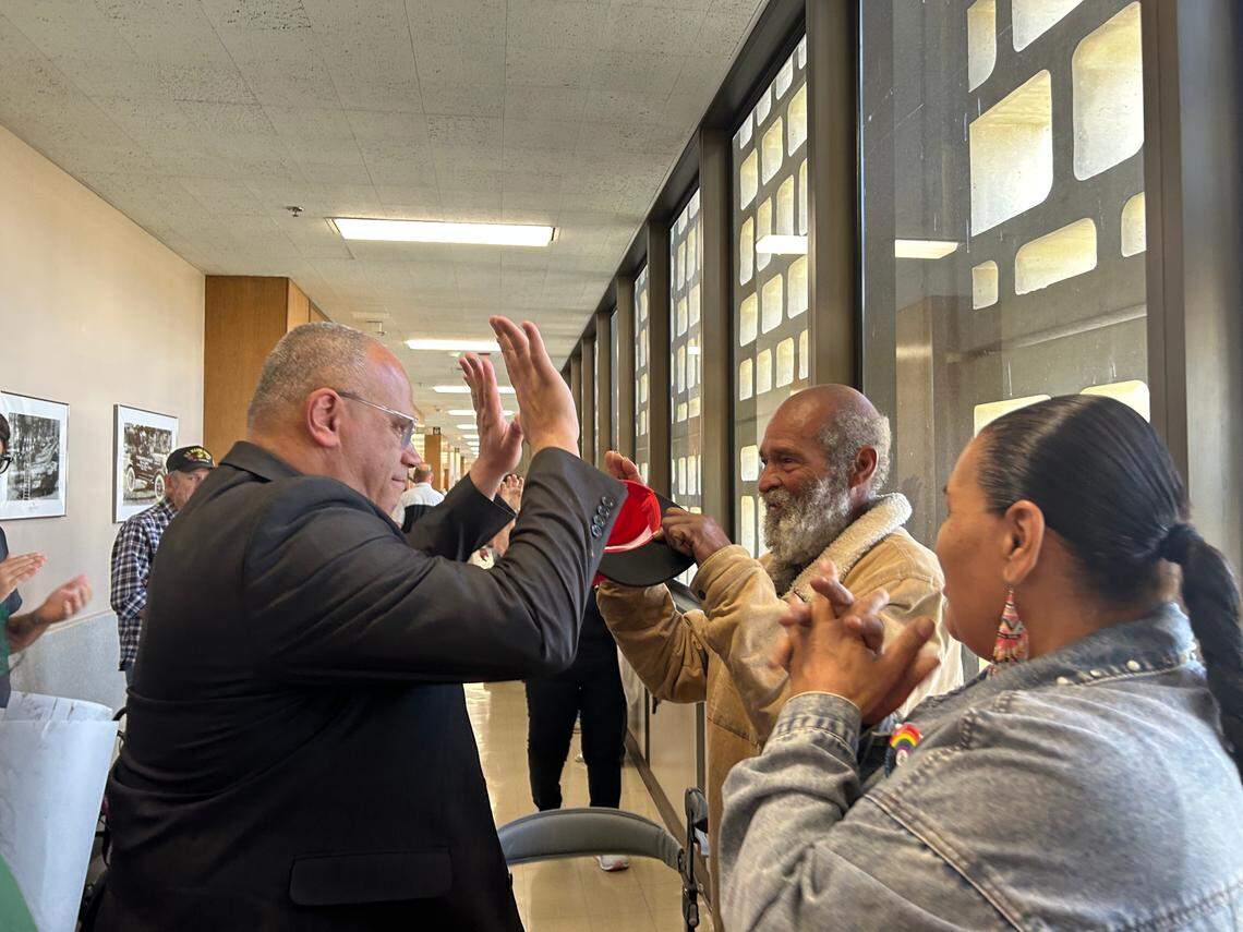Attorney Kevin Little, left, high-fives his client, Wickey Two Hands, outside a Fresno County courtroom Thursday, April 10. They were celebrating the dismissal of the prosecution against Two Hands under the city of Fresno’s anti-camping ordinance.