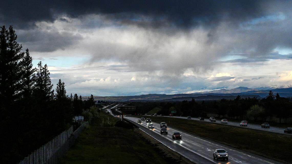 Dark clouds move over Highway 41 at the San Joaquin River in north Fresno before rain showers dampened the commute on Tuesday, Feb. 22, 2022.