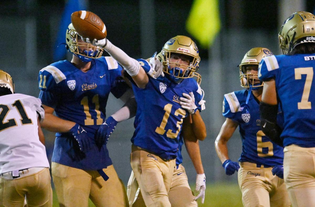 Clovis High’s Palmer Johnson, center, celebrates his interception against Graces Thursday, Aug. 17, 2023 in Clovis.