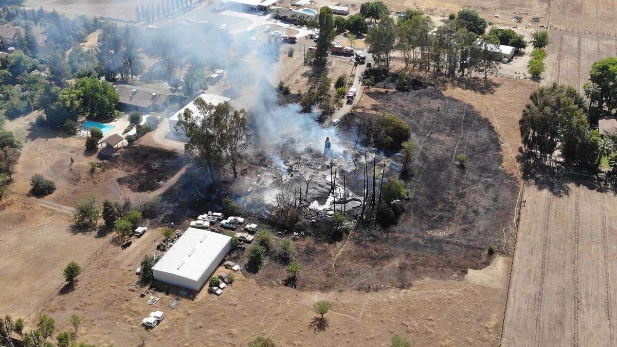 A grass fire spread to a home, injuring a person on Tuesday, May 31, 2022.