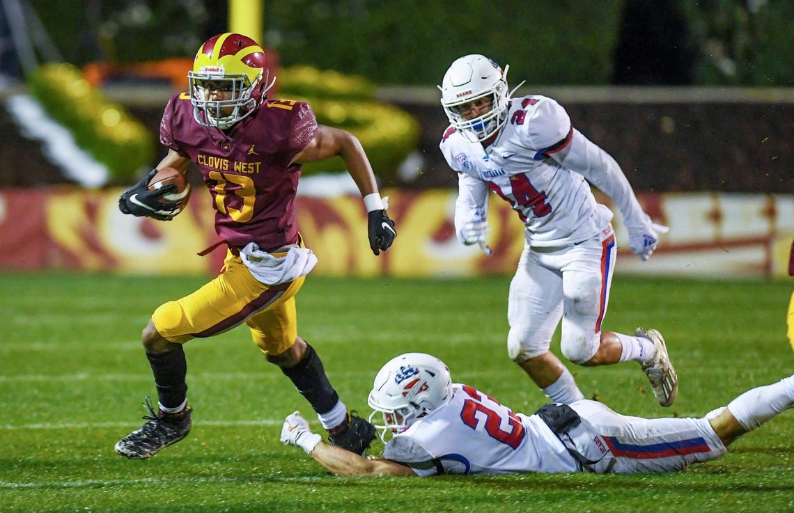 Clovis West’s Isaiah Howard, left, crosses the field with the ball as Buchanan’s Hayden Petersen tries to make a tackle during their game at Lamonica Stadium in Clovis on Friday, March 19, 2021.