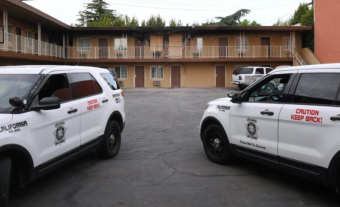 A second floor room, top center, can be seen boarded up at the Plaza Motel on Saturday, April 24, 2021, in downtown Fresno. A man was found outside with severe burn injuries and another person dead inside the room after an early-morning fire.