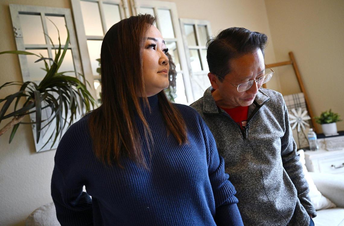 May Lee, left, with her husband Brandon Vang, right, talk about the negative attack mailer they and others have received during his candicay for Fresno City Council which they said points to “dark money,” in an interview Wednesday, March 12, 2025 in Fresno.