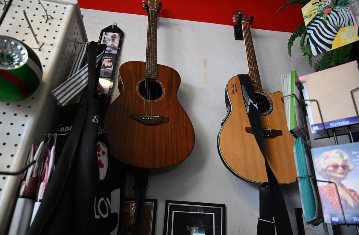 Two acoustic guitars, available for play when Melvin Mason, known as Kuzzin Mel, leads others outside Scoops, Soups & More on Pollasky Avenue in Old Town Clovis Thursday, Feb. 20, 2025.