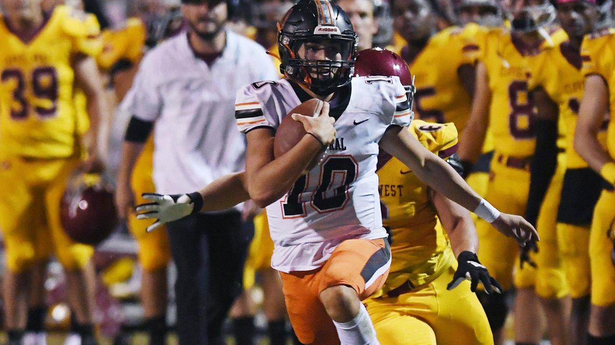 Central quarterback Dayton Tafoya, center, is chased by Clovis West’s Jayden Gonzales, background, Thursday, Oct 21, 2021 in Clovis.