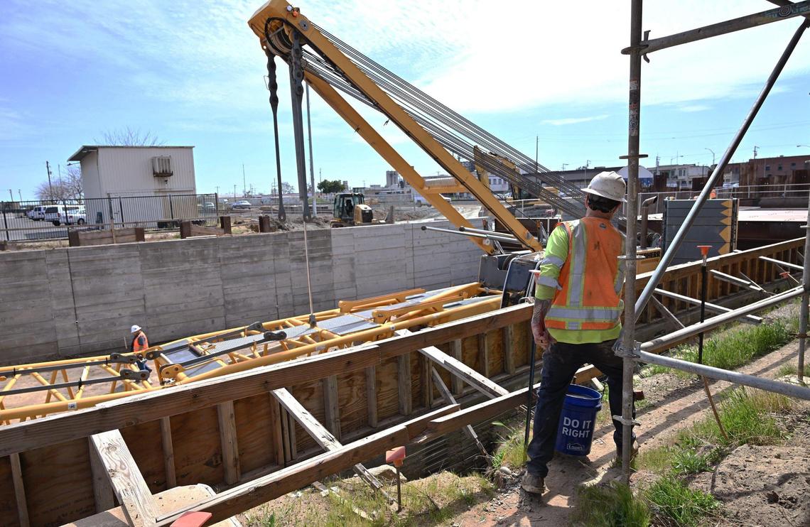 A worker steps around scaffolding at construction site for the Tulare Street underpass during a tour of high-speed rail development in Fresno in 2024. 