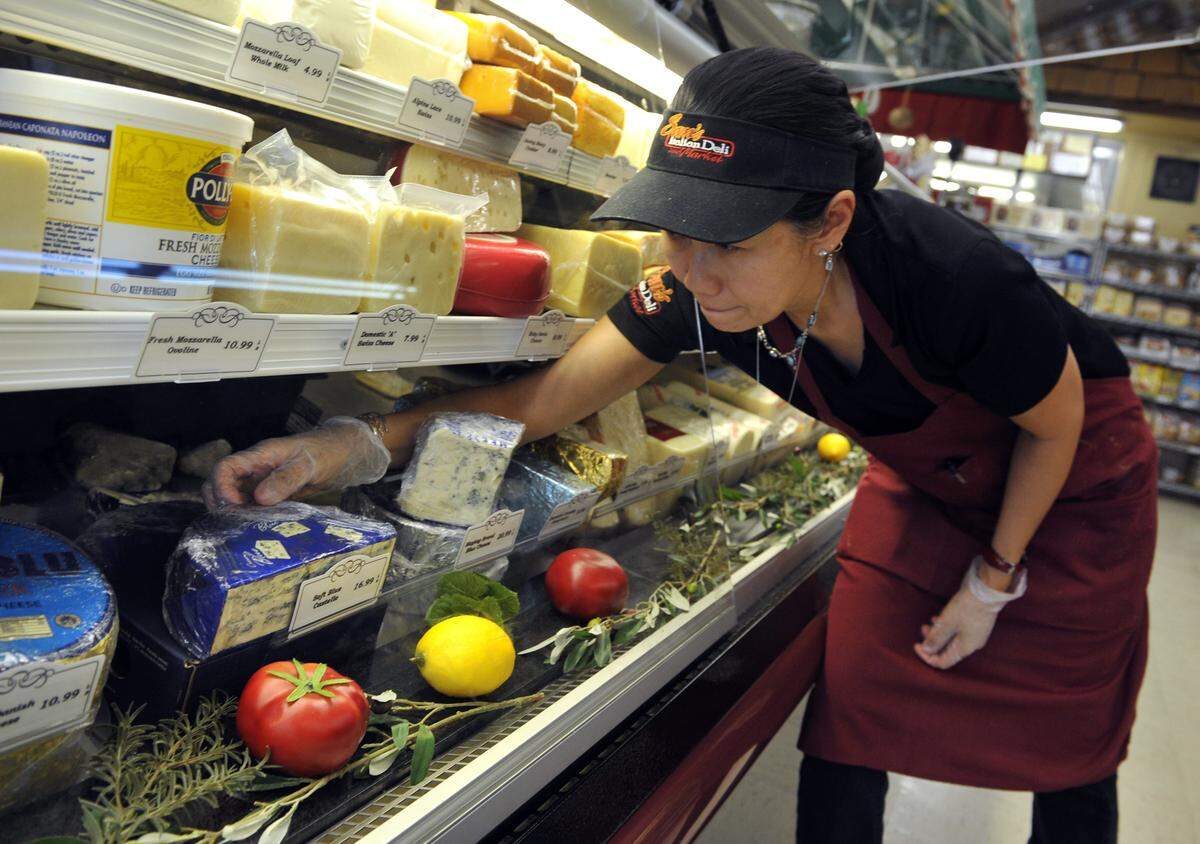 Marlene Goulet displays cheeses at Sam’s Italian Deli and Market in this file photo from 2014.