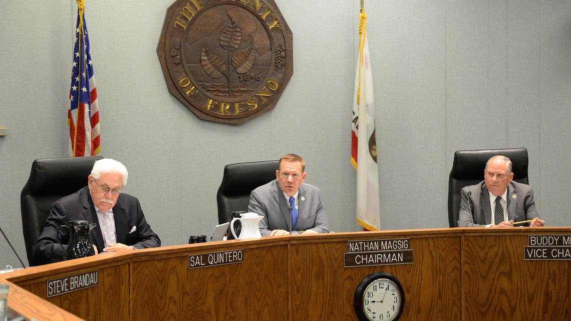 Members of the Fresno County Board of Supervisors, from left, Sal Quintero, Nathan Magsig, and Buddy Mendes conduct business at the dais in 2019.