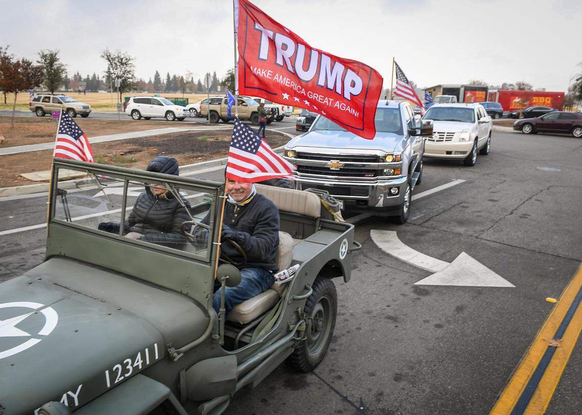 A WWII era Jeep starts a car parade to show support for President Donald Trump during a rally hosted by the Fresno County Republican Party at Sierra Meadows Park in Clovis on Saturday, Dec. 12, 2020.