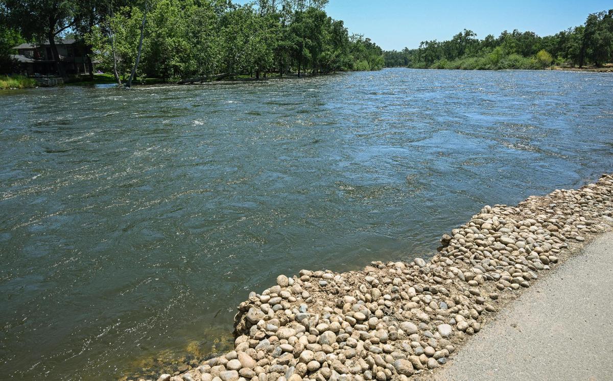 The Kings River flows at a high rate causing some bank erosion near a housing area north of Highway 180 and Piedra Road in eastern Fresno County on Wednesday, May 17, 2023.