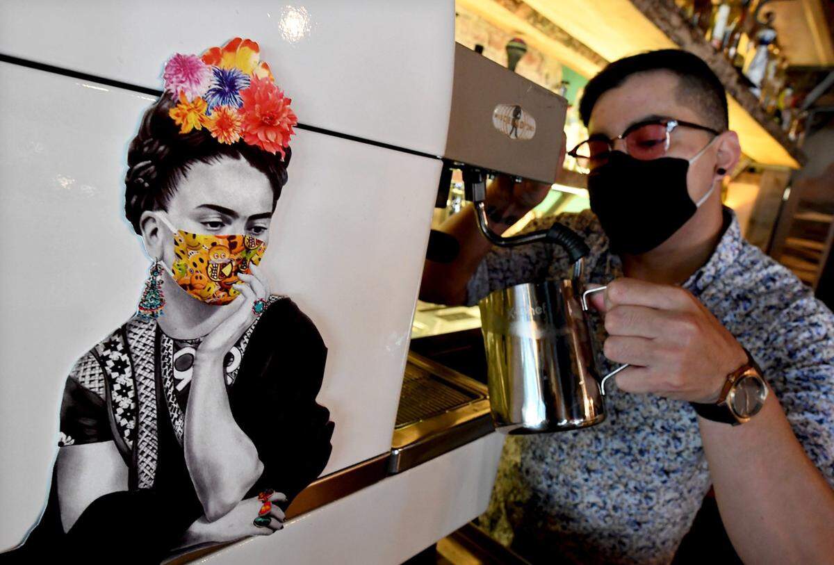 Whimsical, pandemic-inspired artwork of Frida Kahlo adorns an espresso machine in Albee Sanchez’s Frida Café. Sanchez wants to move his business into downtown Fresno’s historic water tower, while continuing to run it as a visitors center.
