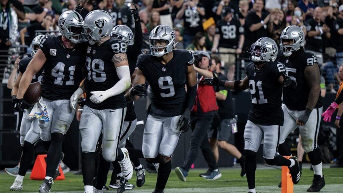 Robert Spillane, left, celebrates after an interception against the Green Bay Packers on Monday, Oct. 9, 2023. The Raiders meet the Patriots on Sunday, Oct. 15, 2023.