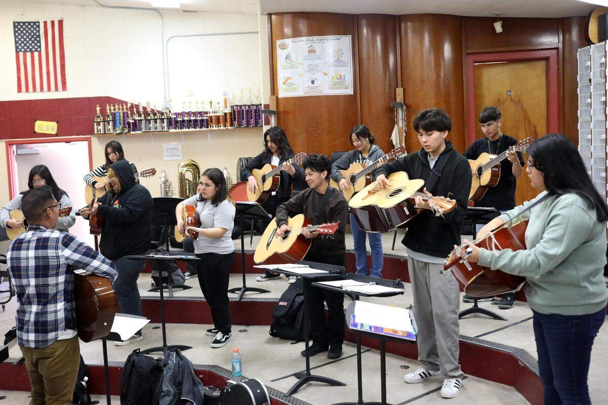 Orosi High School Mariachi Cardenal members listen to Orosi mariachi band director Jonathan Gaspar during their mariachi class on Wednesday, March 15, 2023.