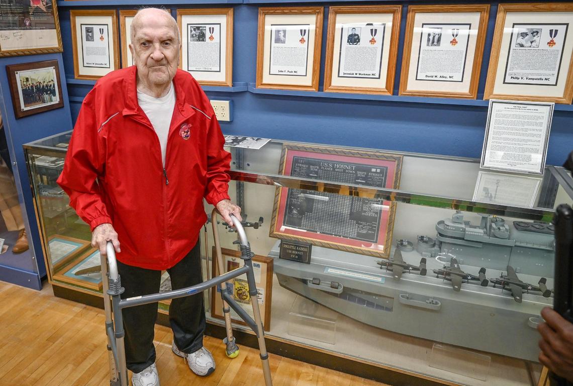 Bob Cole, 100, stands near a model of the aircraft carrier USS Hornet (CV-8), on which Cole served, on the 80th anniversary of the sinking of the ship, while visiting the Veterans Memorial Museum in Fresno on Wednesday, Oct. 26, 2022.