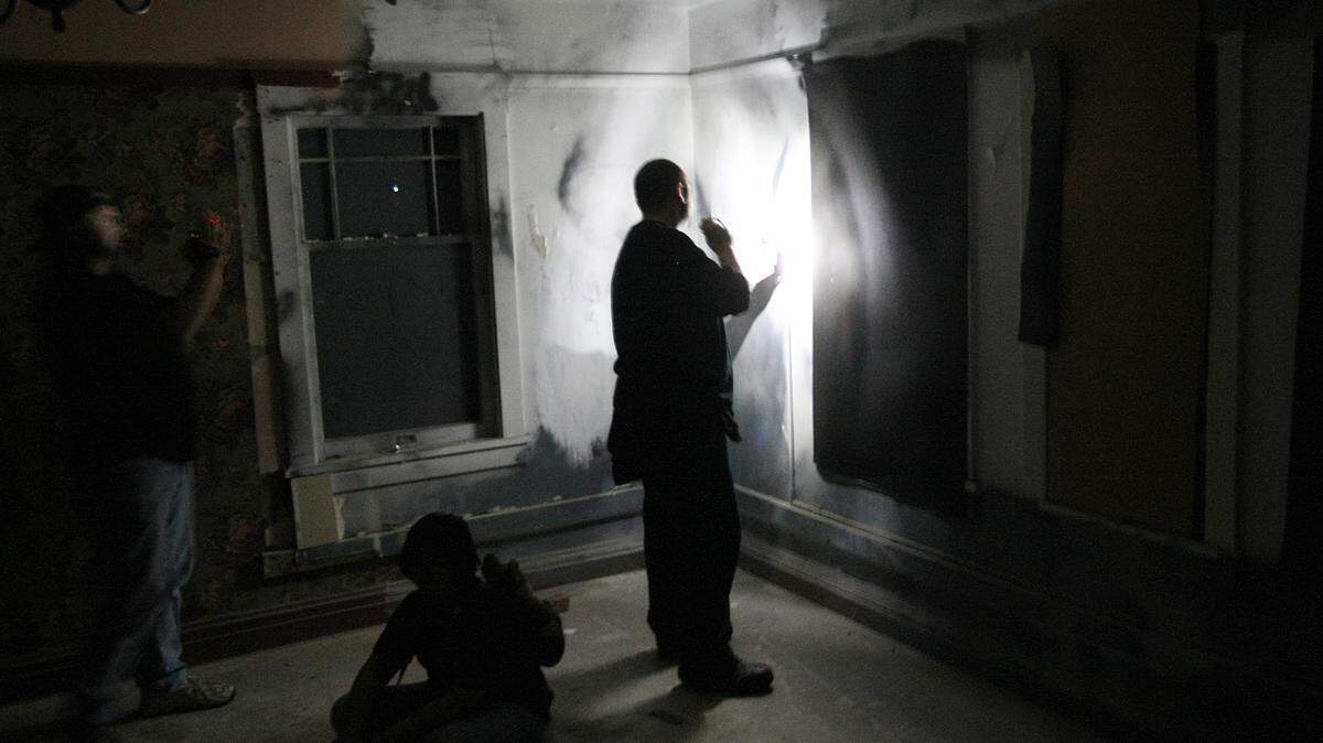 Paranormal investigators search for clues at Wolfe Manor in Clovis.