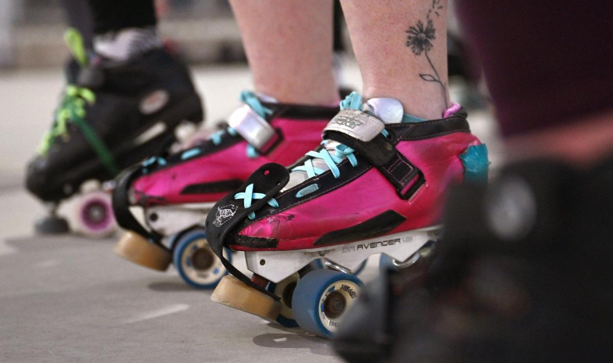 Members of the Ash City Roller Derby team show their roller skates during a practice at Cary Park on Thursday, May 6, 2025, in Fresno, California.