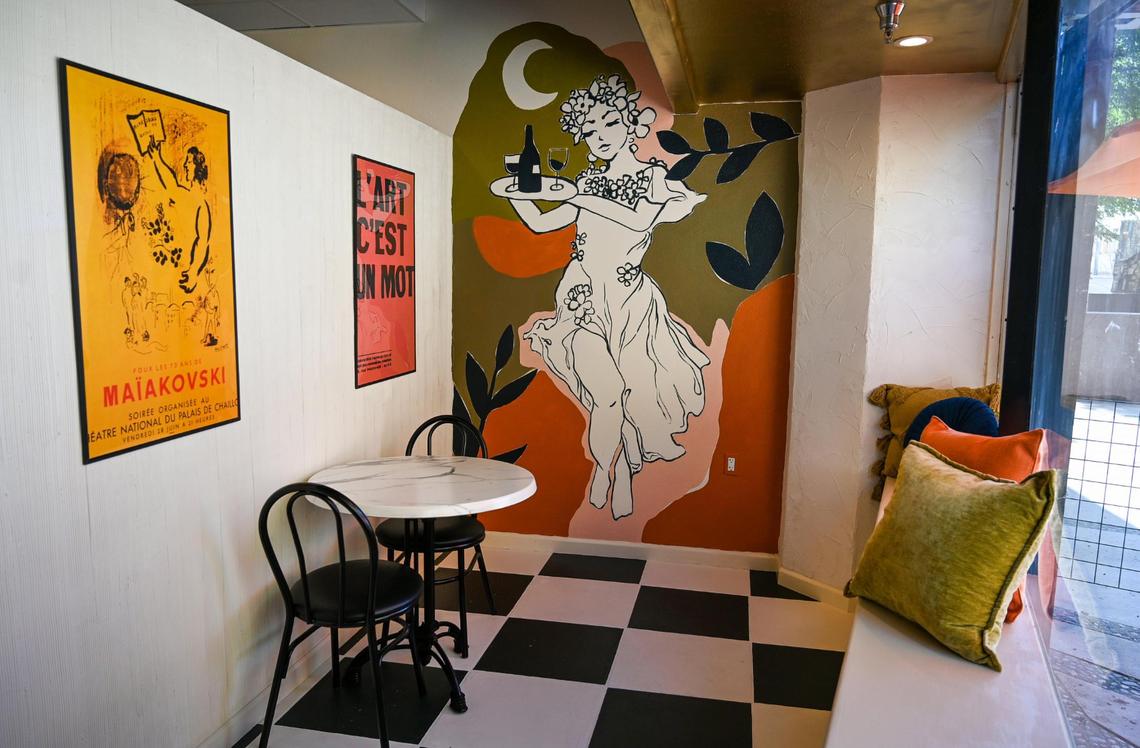 A cozy atmosphere with hand-painted murals and a French motif greet visitors at Lune Wine Bar & Eatery in downtown Fresno.