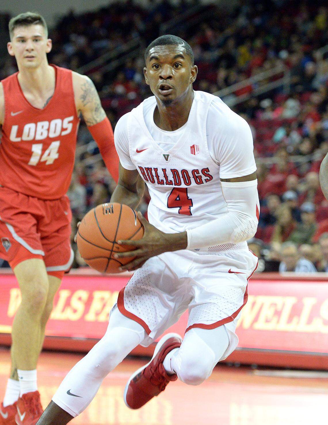 Fresno State’s Braxton Huggins, center, drives to the hoop between New Mexico players Dane Kuiper, left, and Vance Jackson during their game at the Save Mart Center in Fresno on Saturday, Feb. 2, 2019.
