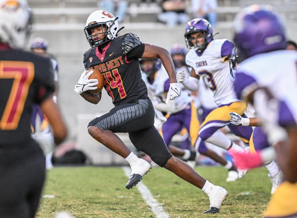 Clovis West’s Landon Wright finds an opening in the Lemoore defense down the middle of the field on his way to a touchdown in the first half of their game at Veterans Memorial Stadium on Friday, Sept. 1, 2023.