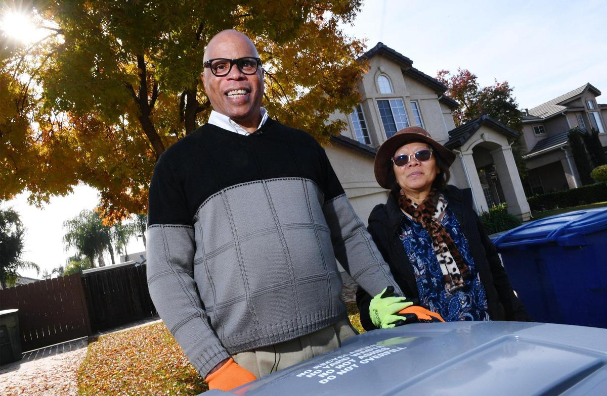 Michael Carter, left, with his wife Doreen Cometa-Carter, regularly commits Random Acts of Kindness as he walks his neighborhood putting away neighbors’ trash cans each Monday. Michael estimates he covers over 400 houses taking up to 5 hours to complete the work. Photographed Monday, Nov. 21, 2022 in Clovis.
