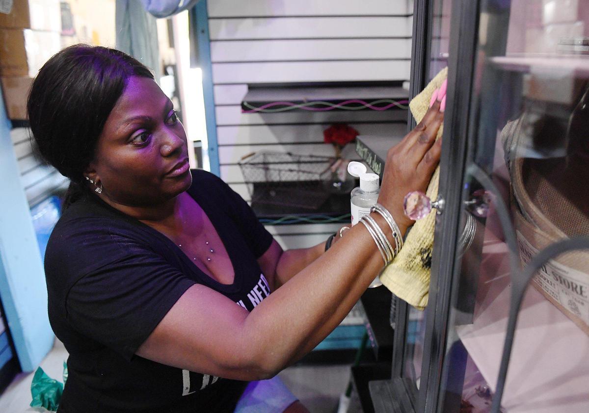 Chanel Wapner, owner of Just My Essentials, cleans up her shop following racist vandalism at her shop Saturday, Sept 26, 2020 in Old Town Clovis.