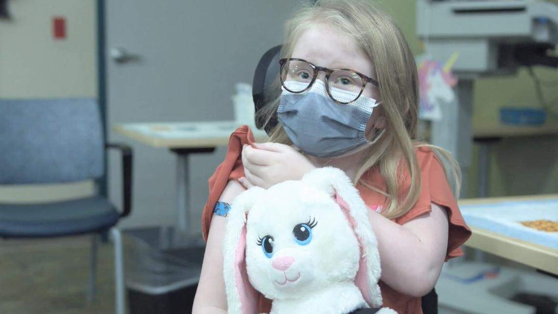 Norah Kerr, age 9, shows off the blue bandage on her right arm after getting her first dose of the Pfizer BioNTech COVID-19 vaccine on Nov. 4 at Valley Children’s Hospital in Madera. She is among about 3,600 children ages 5 to 11 in the central San Joaquin Valley who received coronavirus shots within the first week they were available for that age group.