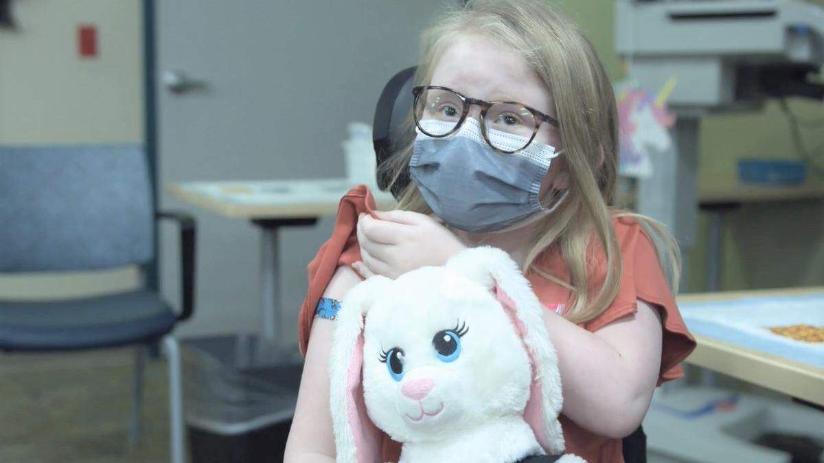 Norah Kerr, age 9, shows off the blue bandage on her right arm after getting her first dose of the Pfizer BioNTech COVID-19 vaccine on Nov. 4 at Valley Children’s Hospital in Madera. She is among about 3,600 children ages 5 to 11 in the central San Joaquin Valley who received coronavirus shots within the first week they were available for that age group.