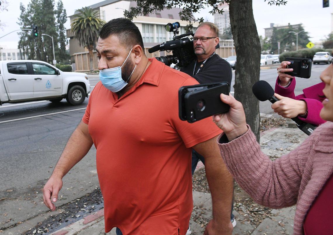 Sanger Mayor Eli Ontiveros, left, is followed by ocal media as he leaves Fresno County Jail Wednesday afternoon, after being taken into custody at his home that morning. Photographed Wednesday, Dec. 22, 2021 in Fresno.