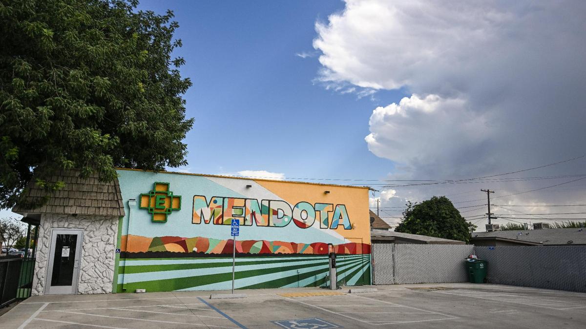 A colorful mural celebrates the heritage and agriculture among the residents of the city of Mendota outside the Element 7 Cannabis Dispensary on Thursday, Aug. 17, 2023.