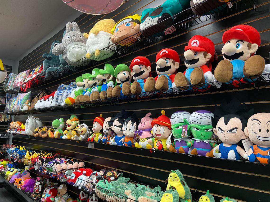 Plush toys featuring video game characters like Mario from Mario Kart, Baby Yoda dolls and even stuffed avocados are for sale at the new location of Blue Shell Gaming & Collectibles.