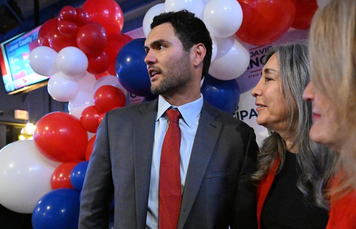 California Assembly District 8 candidate David Tangipa, left, is surrounded by supporters at Field House Tuesday night, Nov. 5, 2024 in Fresno.