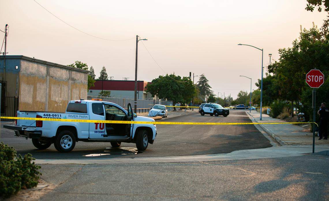 Police tape off the street where River Park security guards were reported to have been shot at by two suspects after a reported theft at the Old Navy in the shopping center Friday, Aug. 6, 2021, in Fresno, California.
