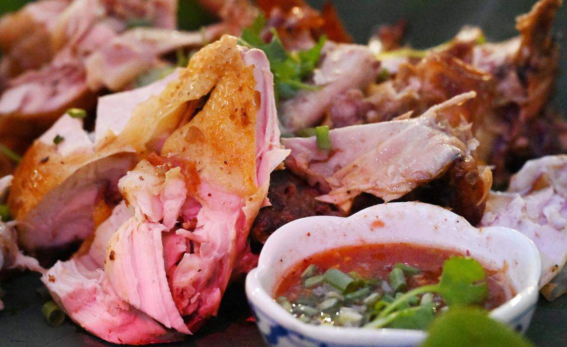 Barbequed Chicken with tomatoe chili sauce is served at Lotus Pond and Night Market which opened earlier this year celebrating the lotus flower and community. The event is a night market offering food and drinks, music and more, is located between Fresno and Sanger. Photographed Friday night, Oct. 10, 2025 near Sanger.