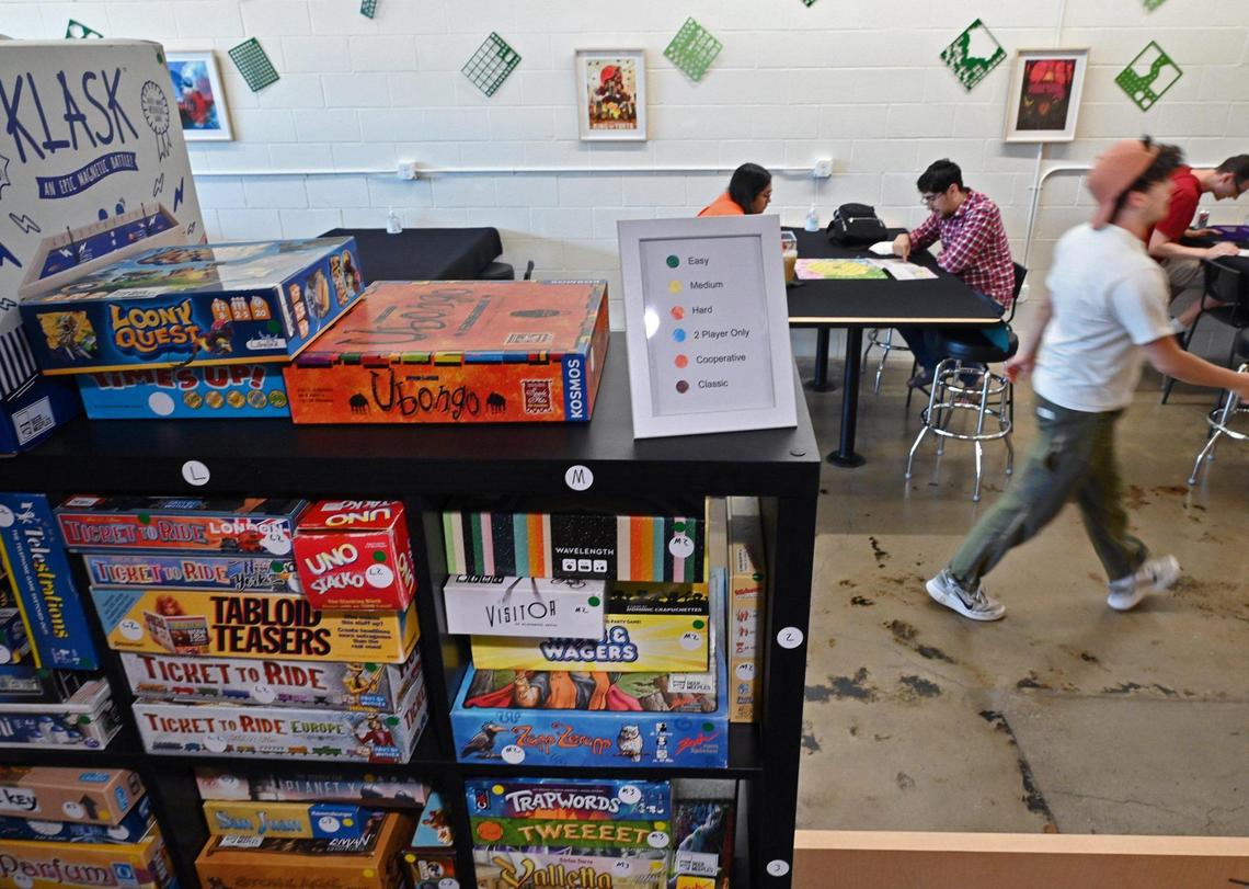 Customers sit at tables and play a board game in the background at Beer for the Meeples located at the corner of Bullard and Minnewawa avenues, Tuesday afternoon, June 14, 2022 in Clovis.