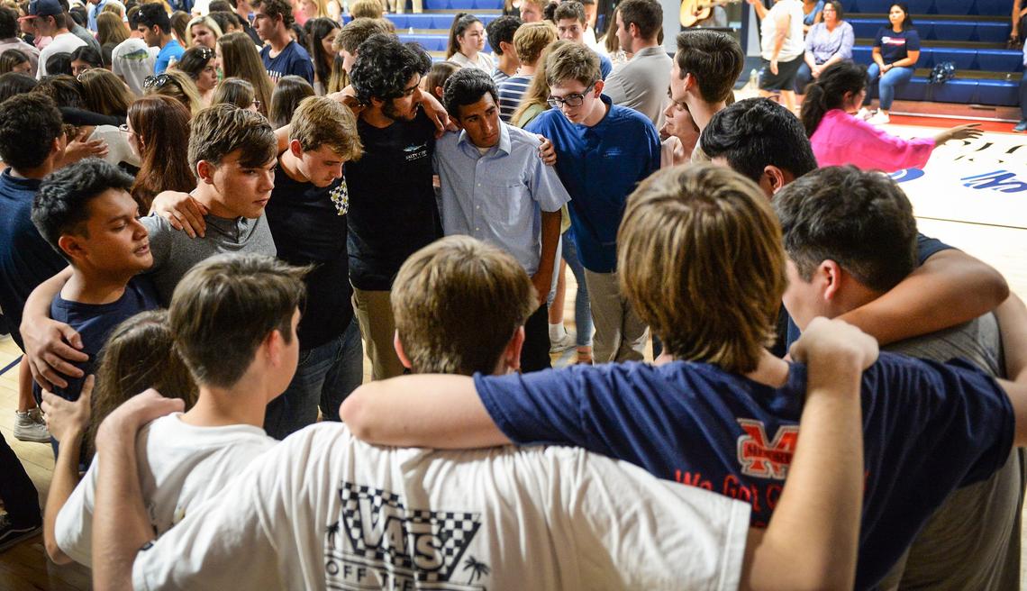 Students, family, friends and faculty gather to console each other during a prayer vigil for San Joaquin Memorial High School student Nick Kauls at the school's gym on Tuesday, June 26, 2018.