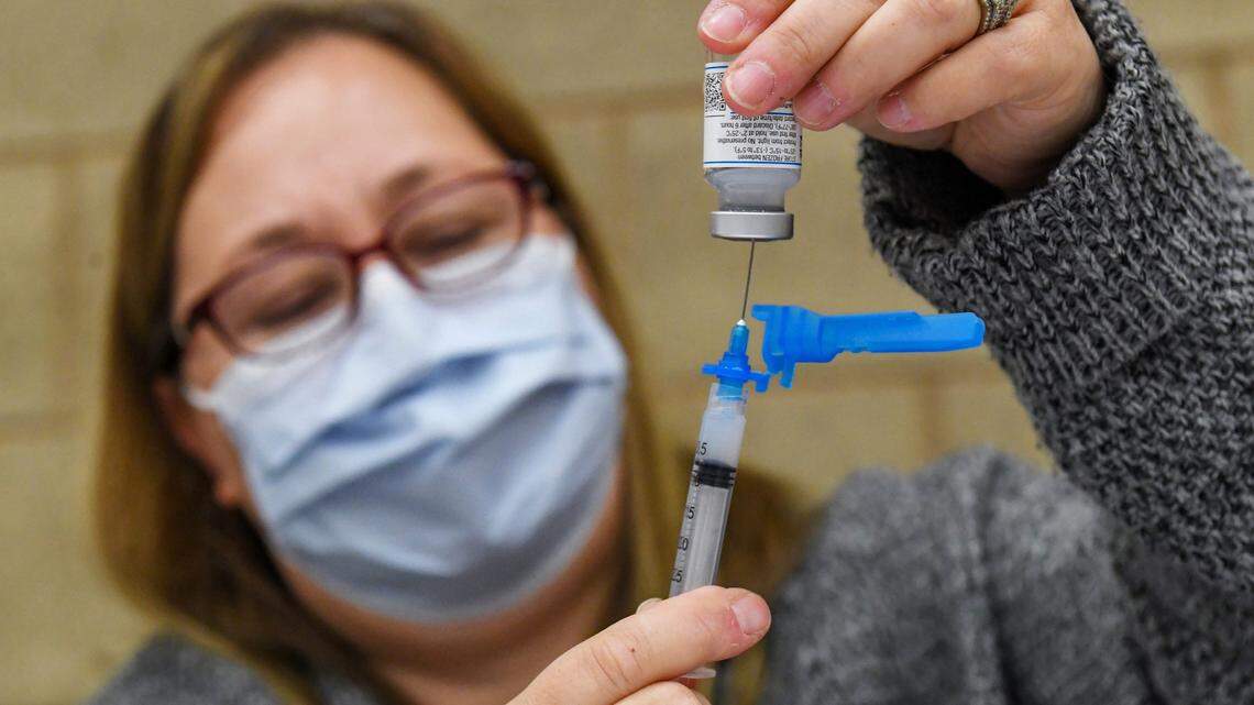 Volunteer Kabrina McCann fills a syringe with a Moderna COVID-19 vaccination dose during a Fresno County rural vaccine clinic at Orange Cove High School on Tuesday, March 16, 2021.