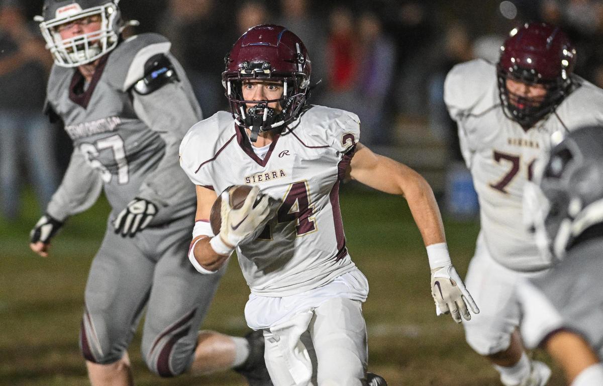 Sierra’s Tanner Forrester takes the ball across the middle against Fresno Christian during their eight-man championship game at Fresno Christian on Friday, Nov. 17, 2023.