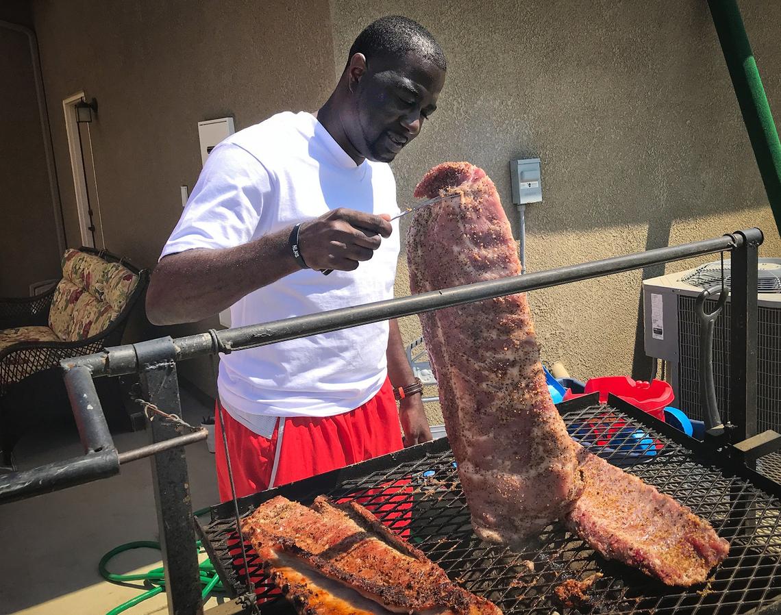NBA reporter Chris Haynes turns over a slab of ribs on during a Labor Day weekend visit to the Clovis home of close friend Terrance Hall to celebrate Haynes’ 37th birthday. Following two years at ESPN, the Fresno native is joining Yahoo Sports.