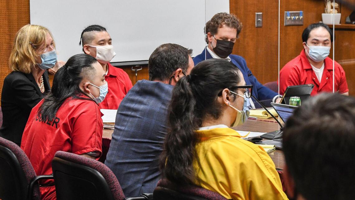Defendants, in orange jumpsuits from left, Ger Lee, Porge Kue, and Billy Xiong and Anthony Montes, in yellow jumpsuit, listen to Judge Arian Harrell with their attorneys during the start of their preliminary hearing in Fresno County Superior Court on Tuesday, Nov. 9, 2021. The four men are charged with murdering four people in 2019 who were gathered in backyard to watch football.