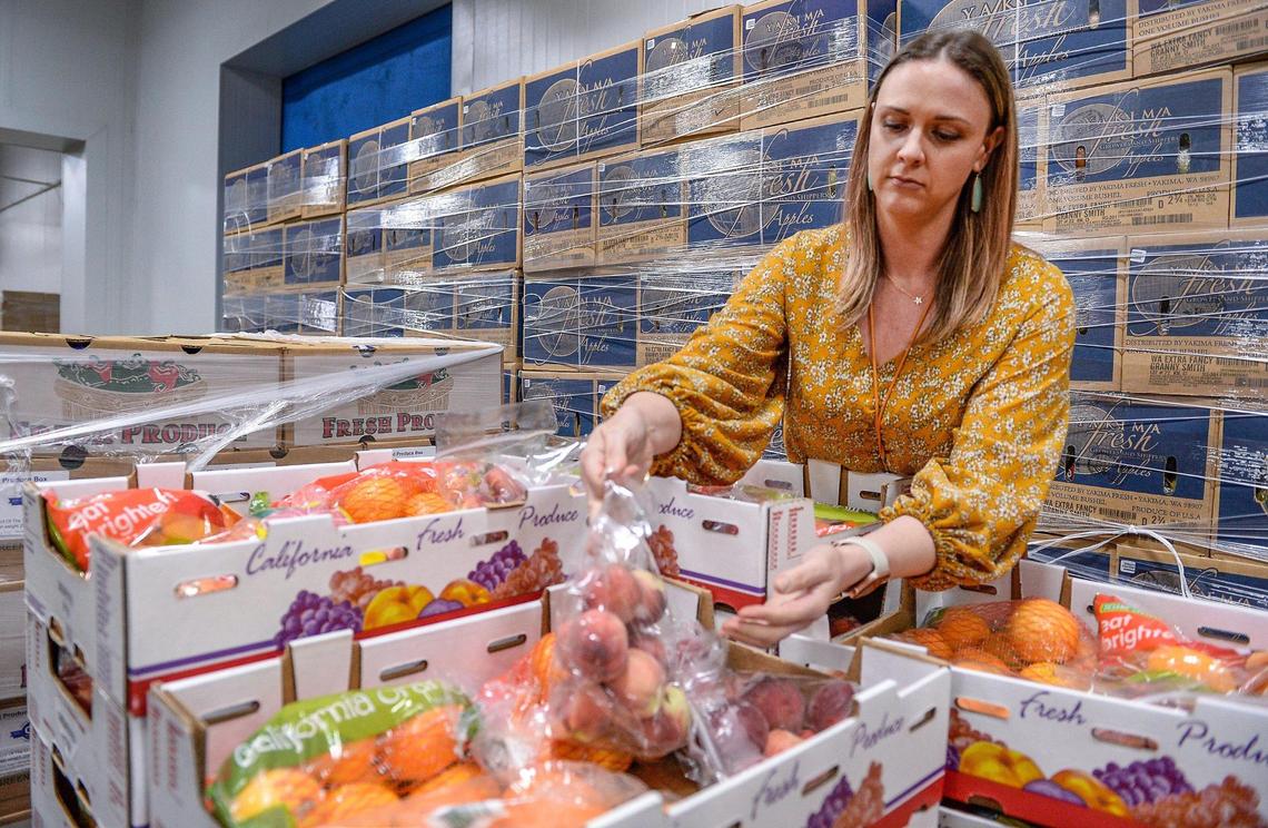 Natalie Caples, co-CEO of the Central California Food Bank, looks over fresh produce packed in the food bank’s warehouse in Fresno on Monday, June 8, 2020.