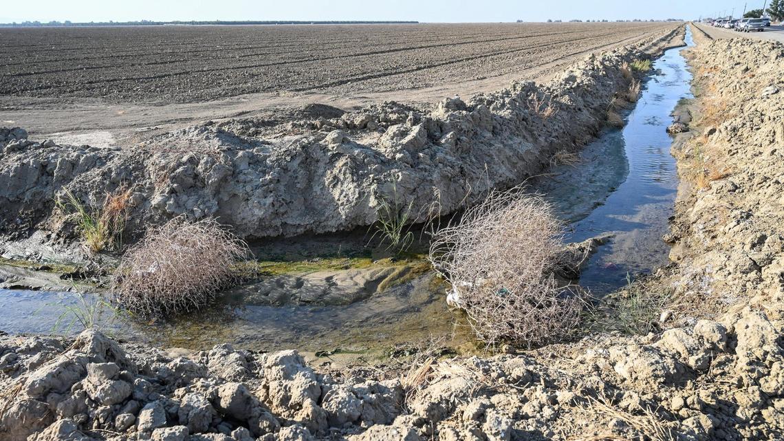 A small amount of water flows in a ditch near an empty field at the edge of the city of Huron. Forecasters don’t anticipate significant near-term rainfall to break the region’s long-term drought.